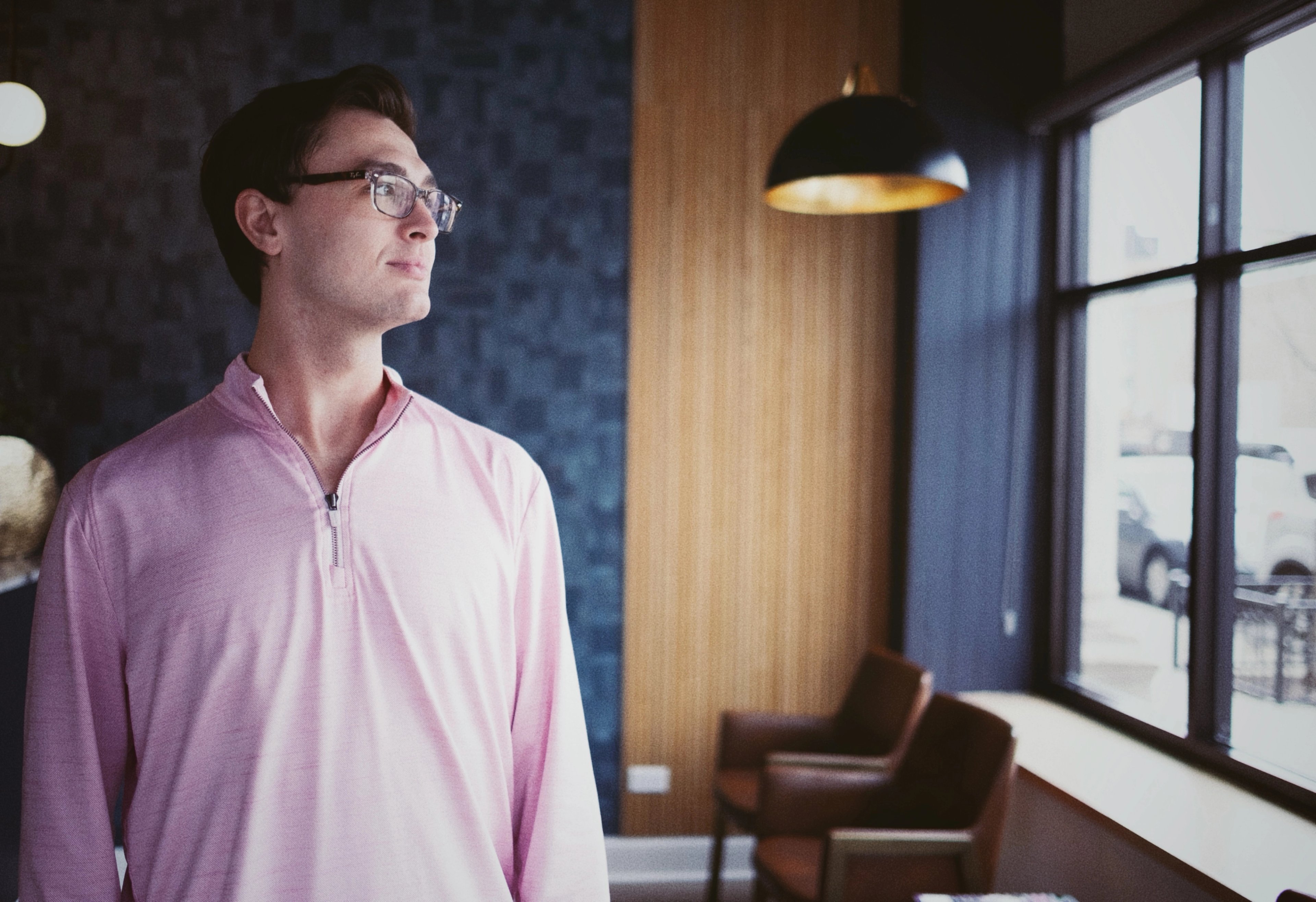 Dr. Jack Geissler standing in his Wicker Park dental lounge, looking toward the window