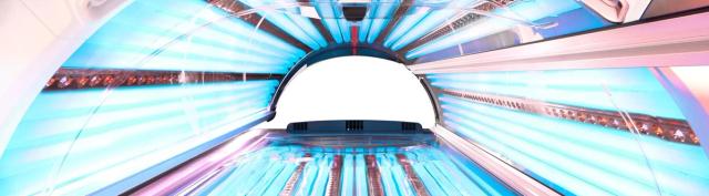 Inside a lay-down sunbed, showing the canopy and lamps