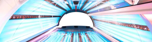 Inside a lay-down sunbed, showing the canopy and lamps