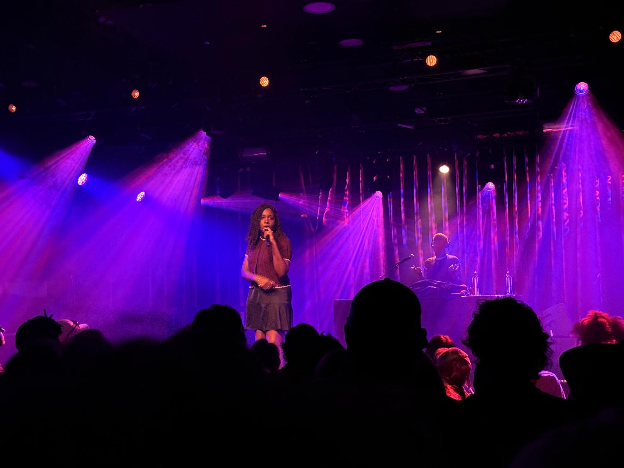noname with a lot of spotlights shining behind her in different directions