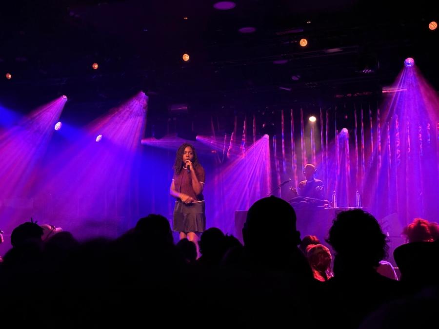 noname with a lot of spotlights shining behind her in different directions