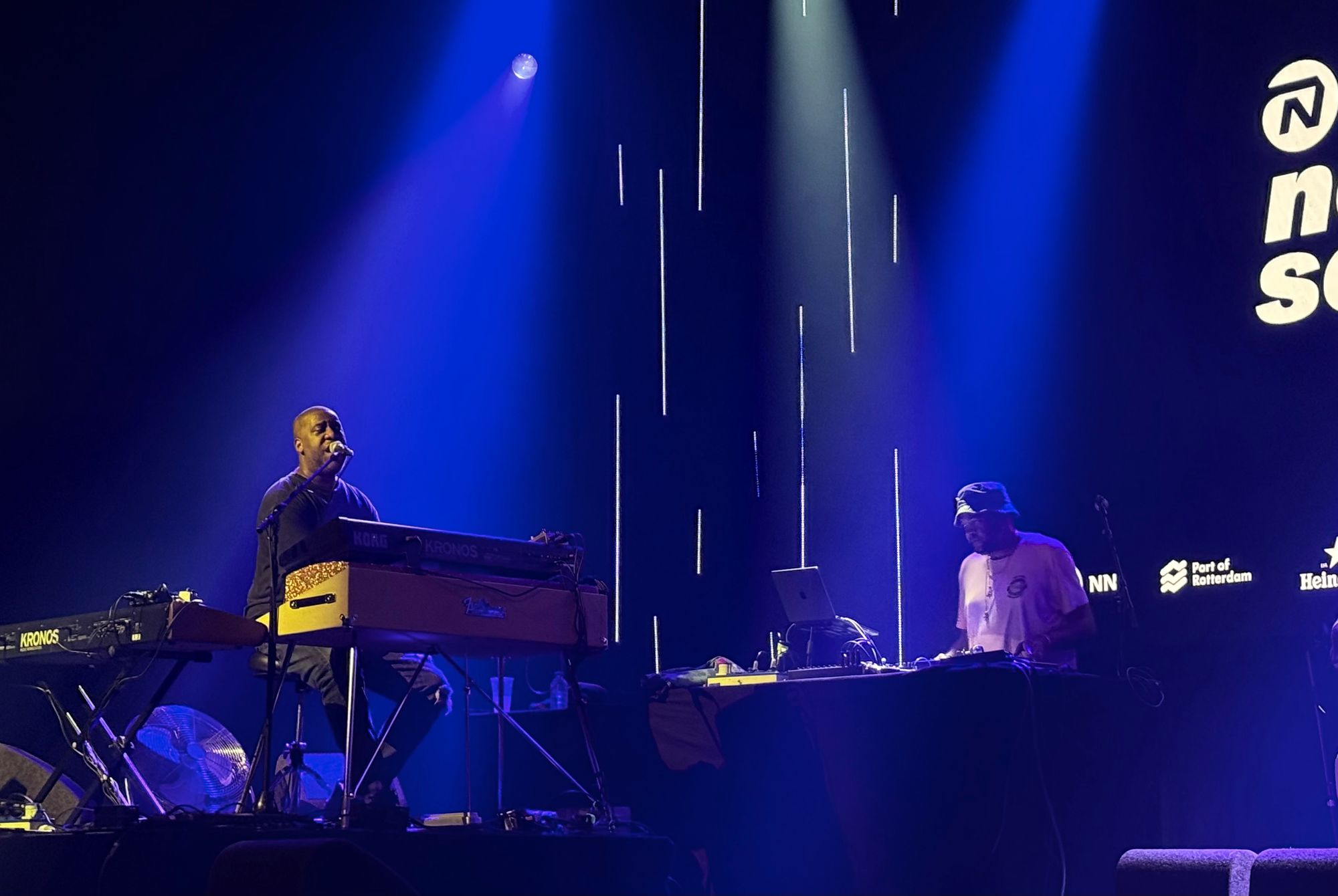 Robert singing while playing piano, DJ Sundance on his right