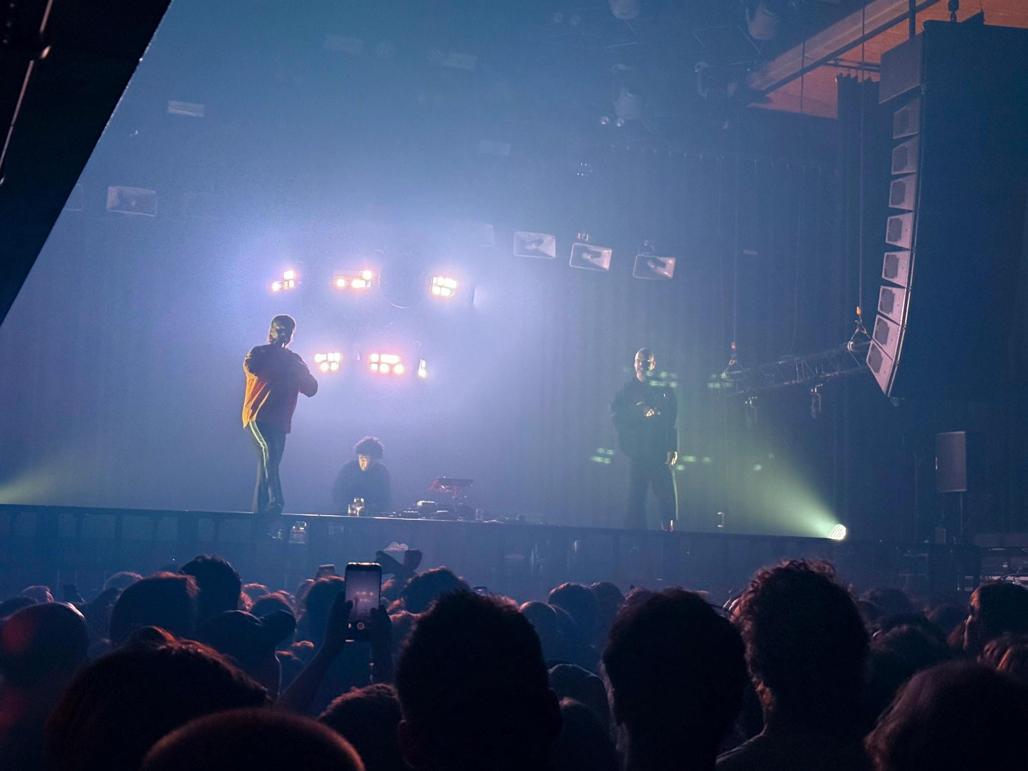 Sef and Abel on a stage with Faisal in between