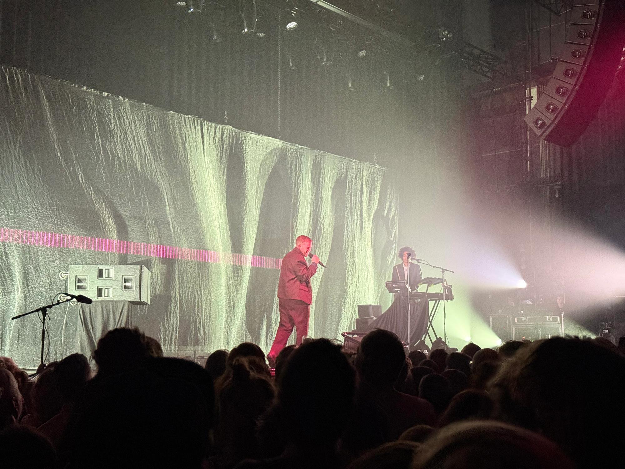 Kae on stage, there is a pink line behind him