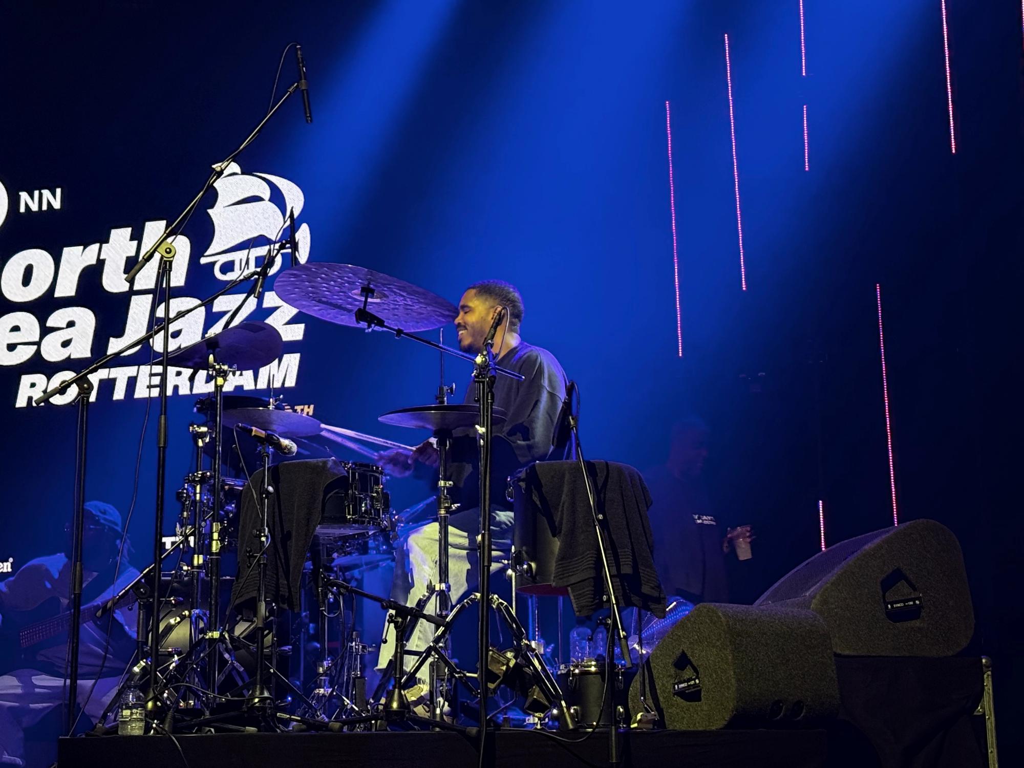 Justin Tyson looking happy playing drums