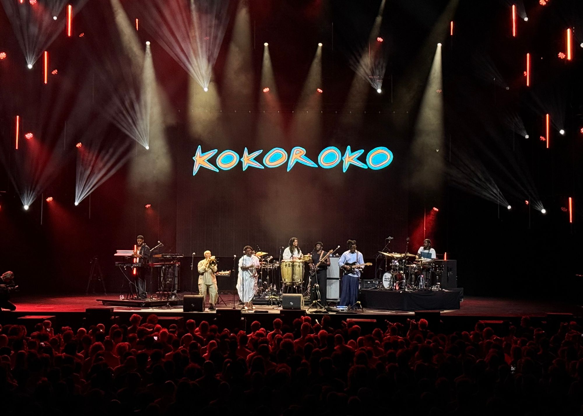 whole kokoroko band on stage with audience visible