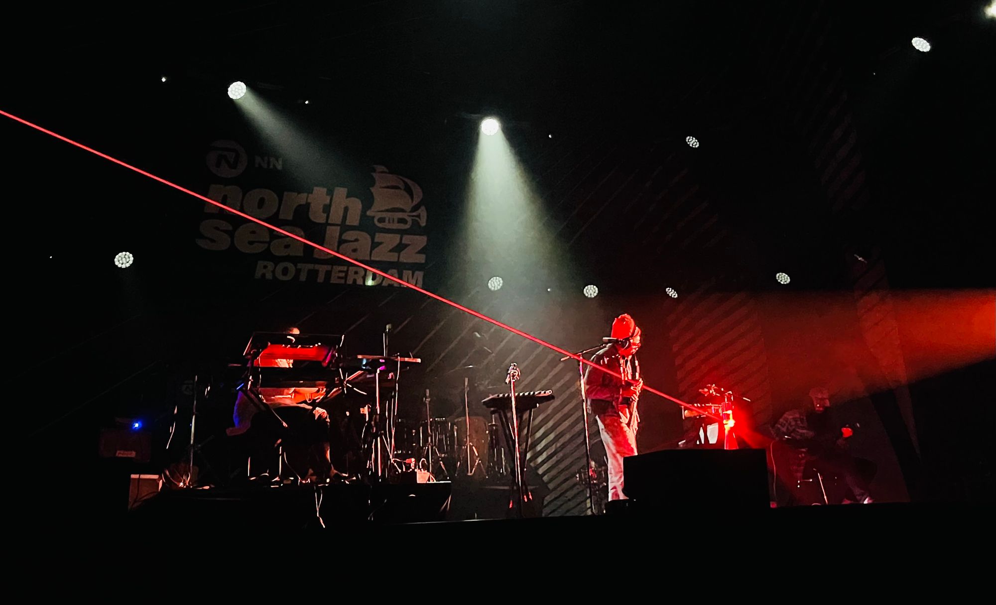 andre on stage with flute, a laser goes from top left to stage