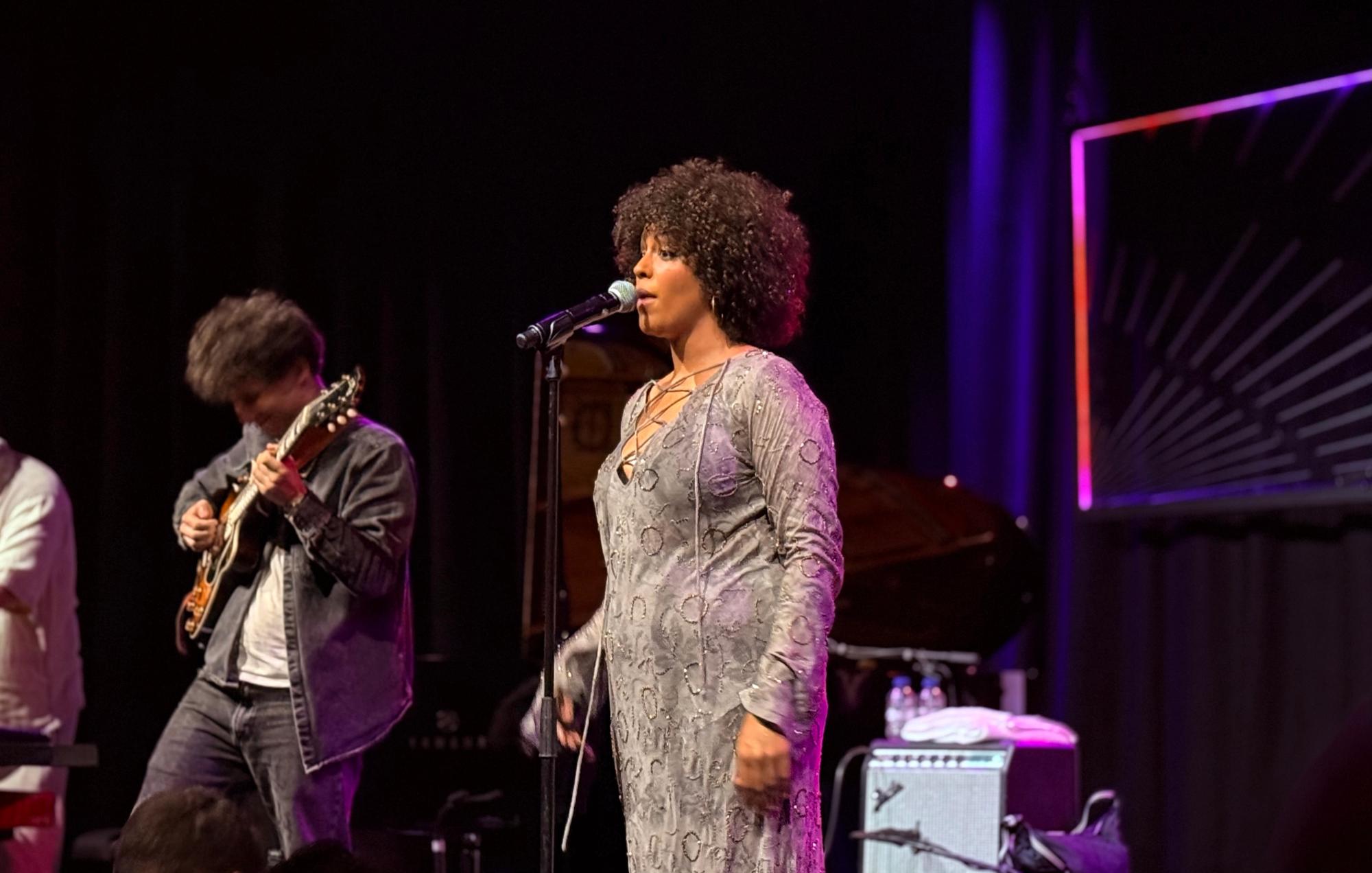 ADJA singing with guitar player on her left
