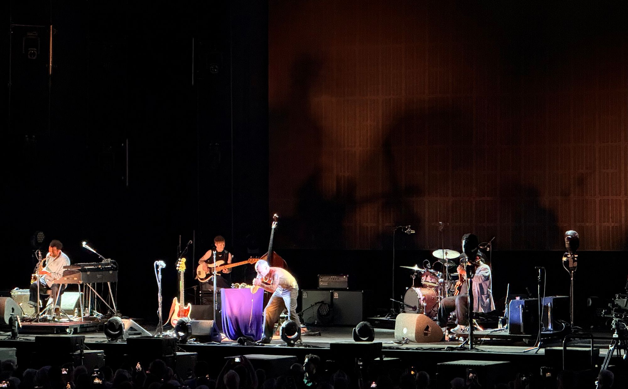Flea singing with band, not wearing a shirt