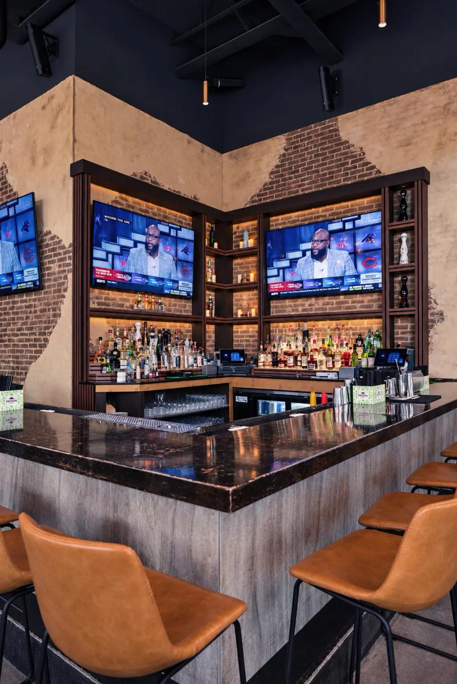 The Cantina Añejo indoor bar with leather stools and TVs