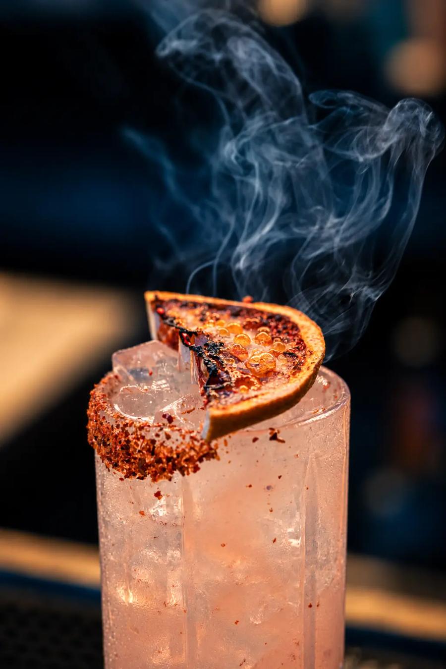 A smoked cocktail with a chili-salt rim and charred orange at Cantina Añejo