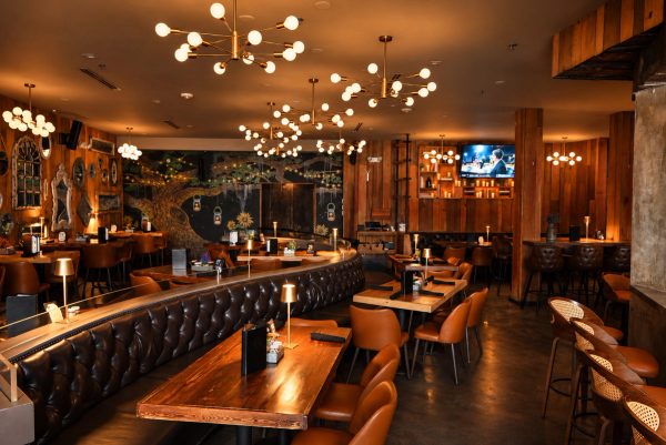 The OAK dining room's leather banquette under the new globe lights