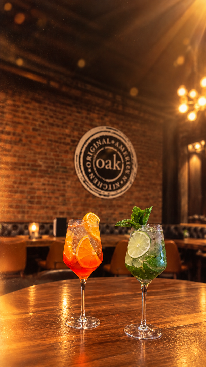 A spritz and a mojito on the bar top under the OAK seal
