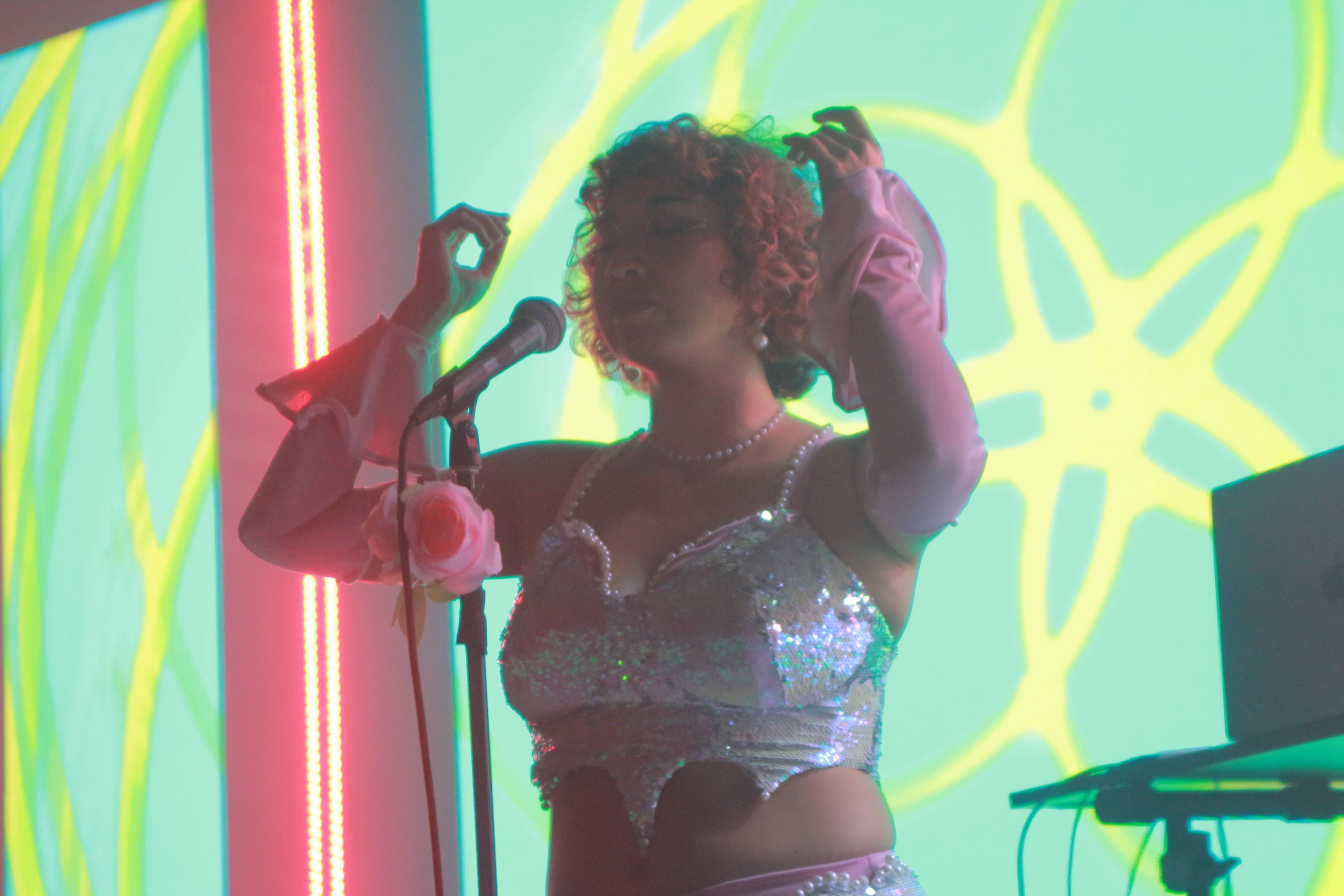 Ruby Mountain performing live in Hollywood, singing and producing dance music with a cosmic vibe from Venus.