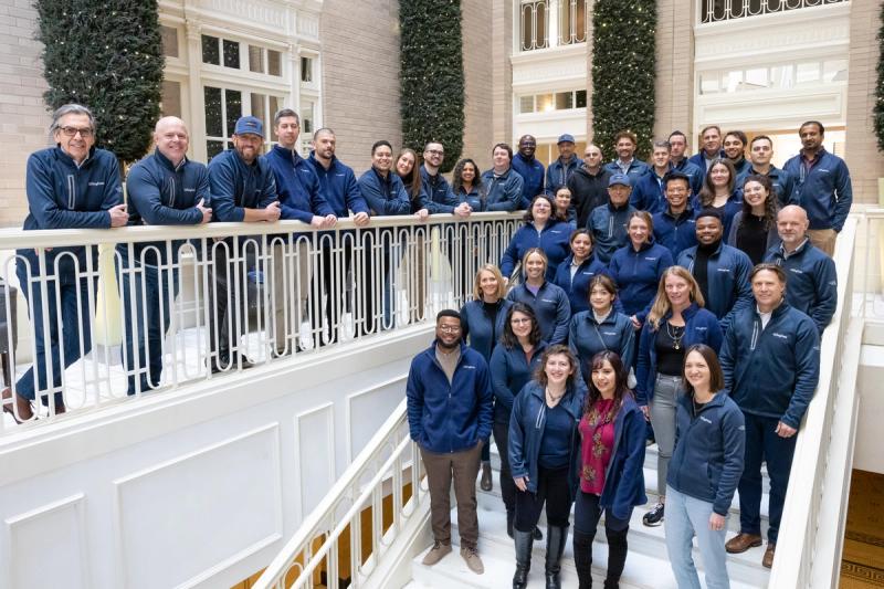 GivingData team group portrait on an indoor staircase during their annual team retreat