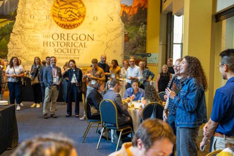 Speaker addressing attendees at GDConnect 2025 conference at the Oregon Historical Society in Portland