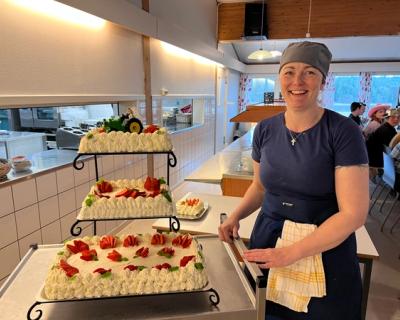 Kokken viser fram tre etasjes kake