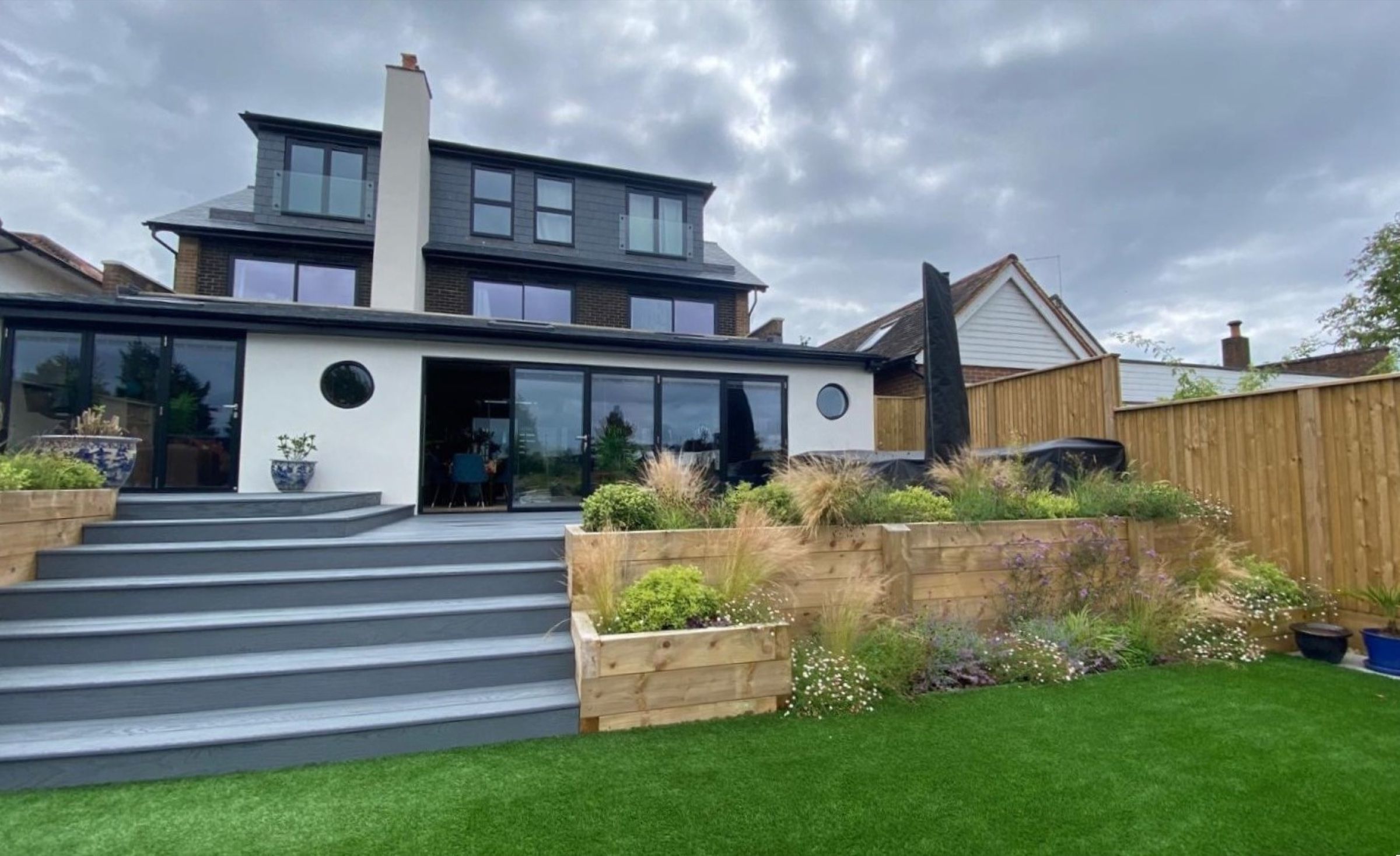 Raised beds and terrace detailing in a family garden