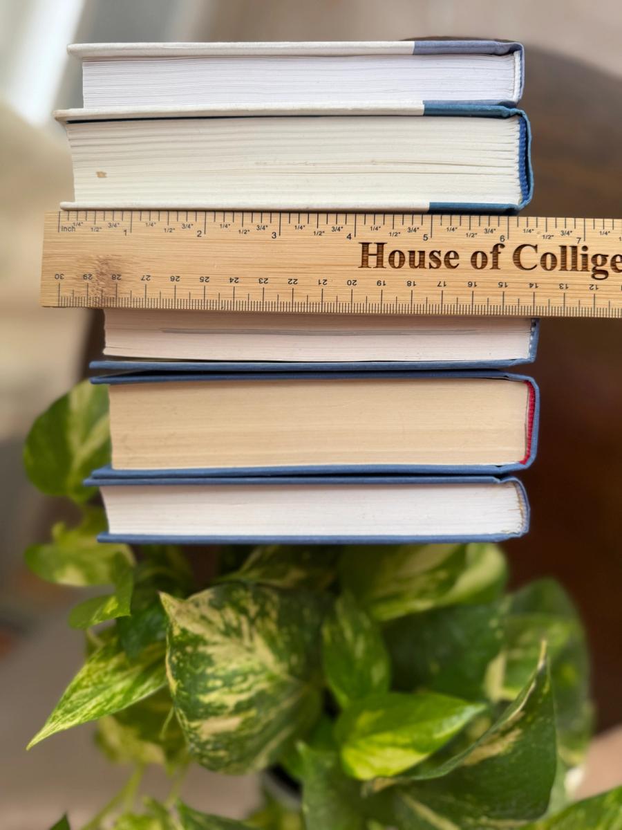 Curated collection of deep navy, warm ivory, brown, and gold-accented books with classic traditional character.