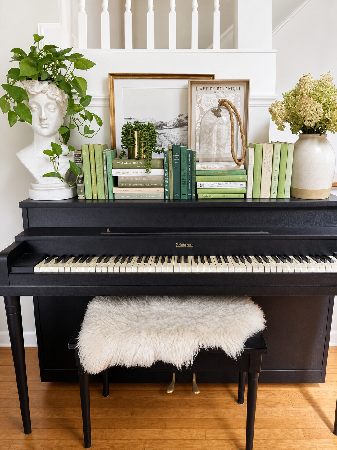 Curated collection of soft sage, olive, cream, and muted green books with botanical tones.