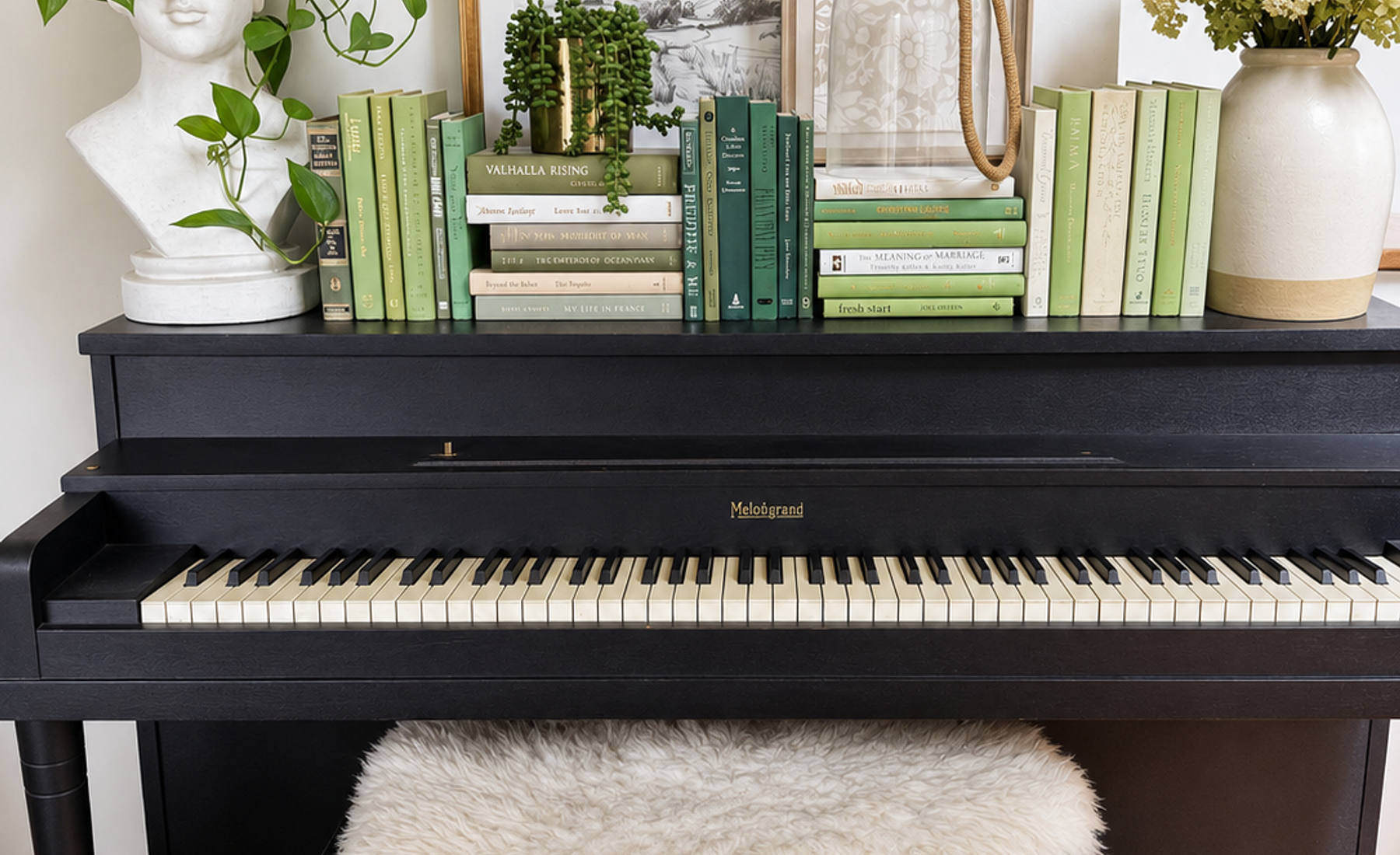Curated collection of soft sage, olive, cream, and muted green books with botanical tones.