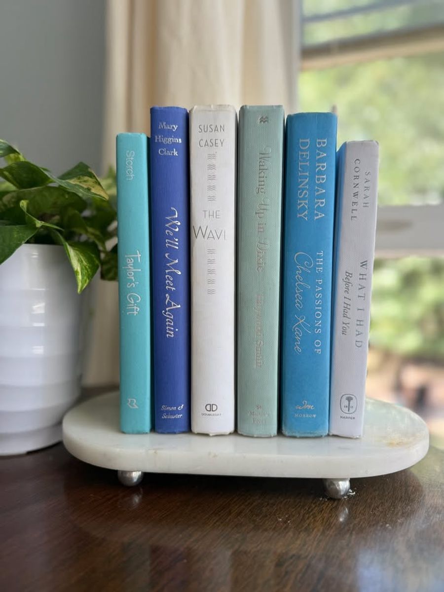 Sea Glass No. 33 decorative book collection in turquoise, cobalt blue, white, pale aqua, and soft gray tones, tied with neutral linen ribbon and styled on a marble table.
