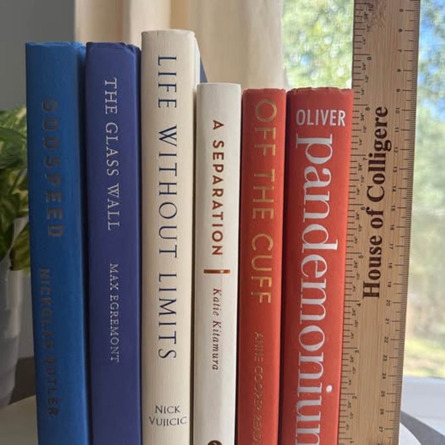 A bold, graphic collection of six hardcover books curated in cobalt blue, deep navy, warm ivory, and coral orange. Strong typography, saturated color, and varied cloth textures give this collection a clean, modern character.
