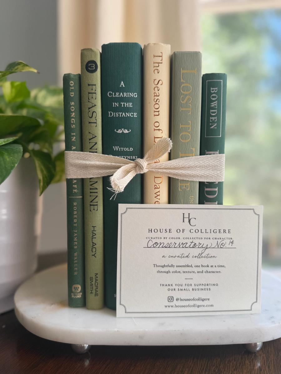 Curated collection of soft sage, olive, cream, and muted green books with botanical tones.