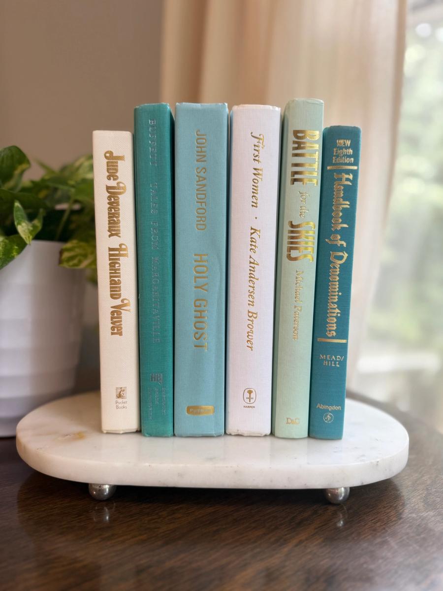 Curated collection of soft blue, aqua, seafoam, and muted coastal-toned books.