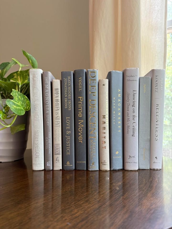 Curated collection of muted blue-gray, slate, charcoal, and softly weathered neutral books.