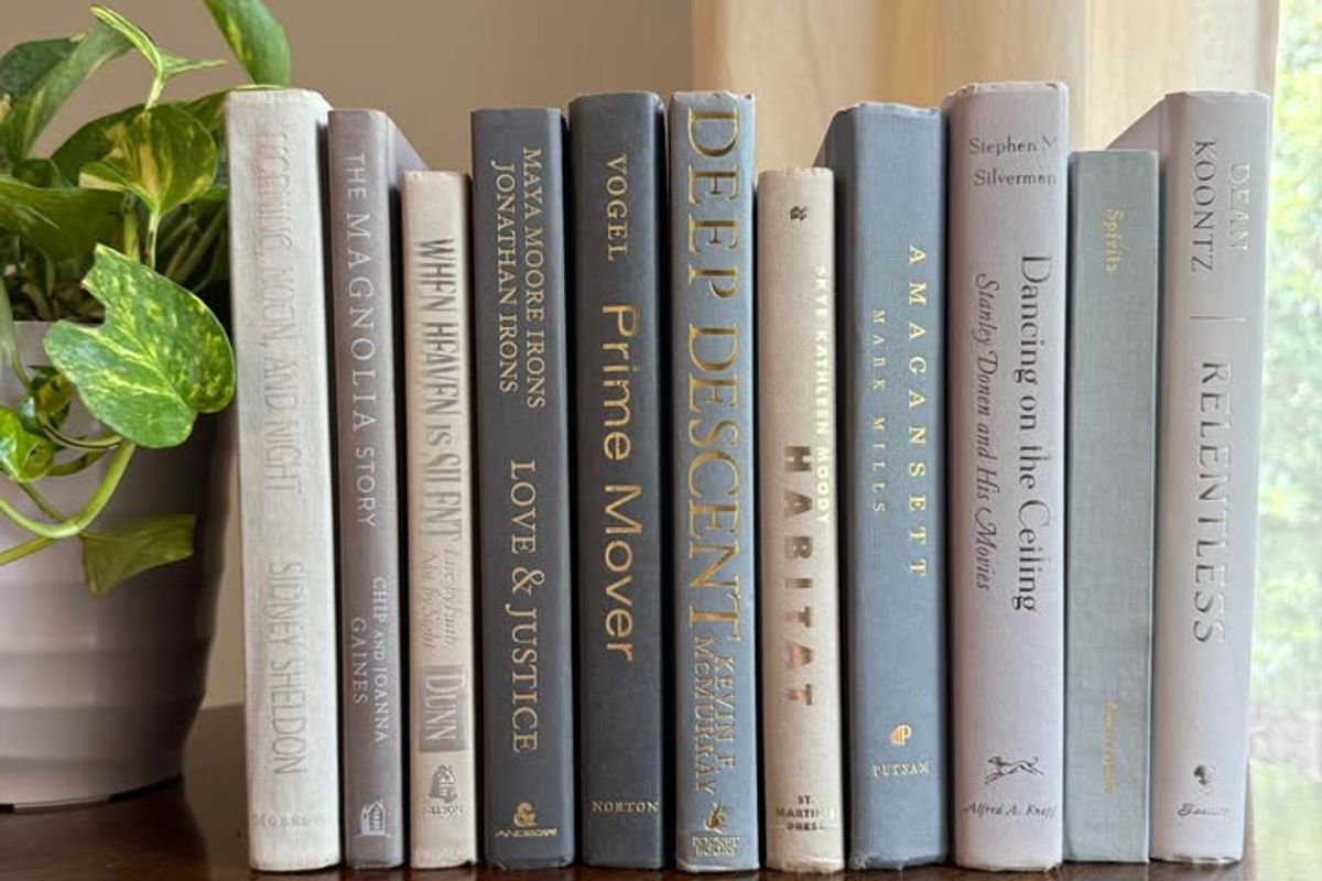 Curated collection of muted blue-gray, slate, charcoal, and softly weathered neutral books.