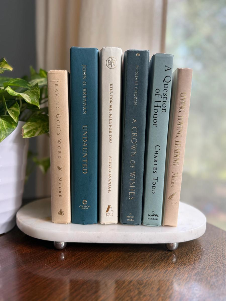 Curated collection of white, pale blue, sand, and soft coastal-neutral books with an airy, sun-faded look.