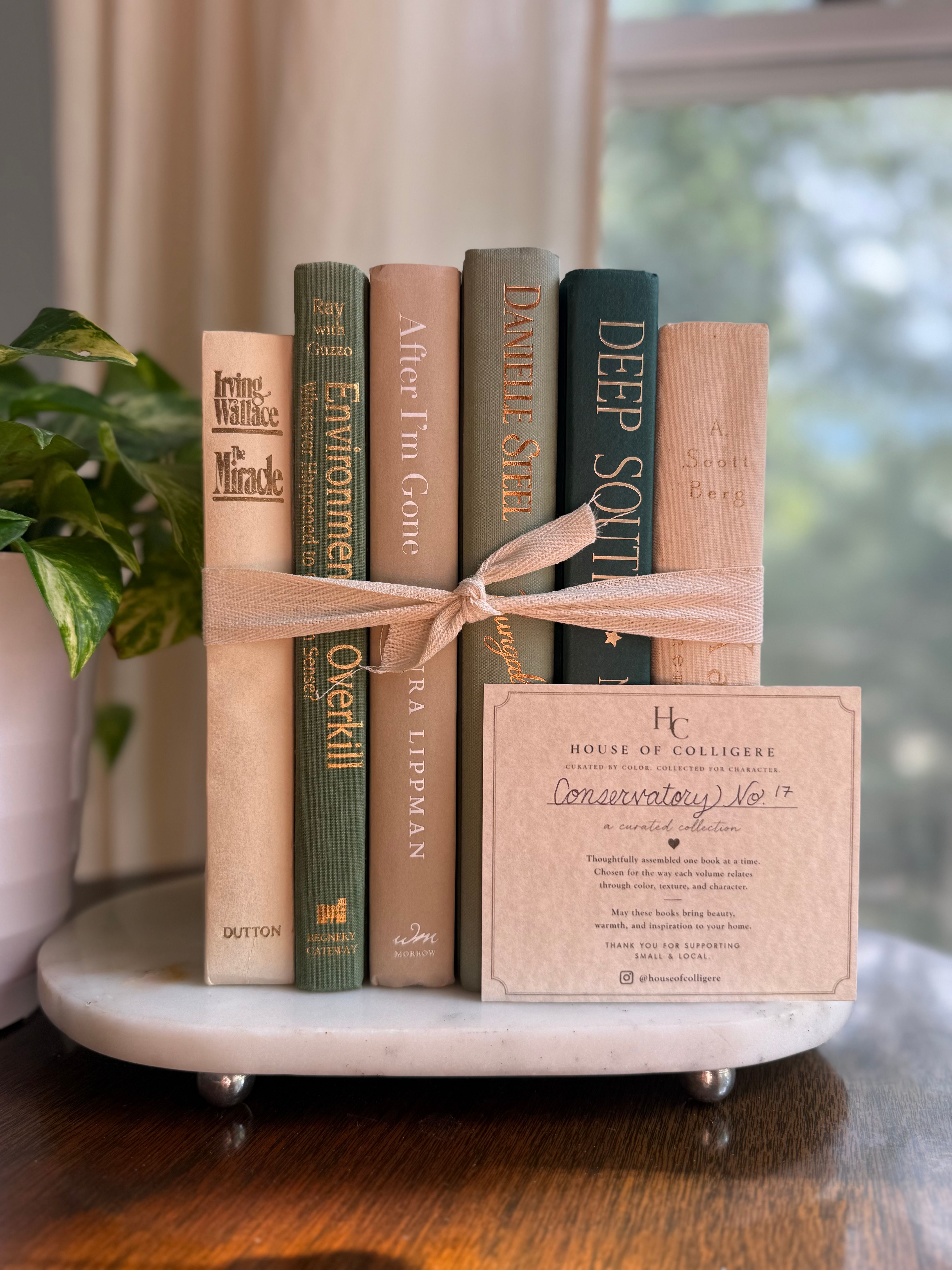 Curated collection of soft sage, olive, cream, and muted green books with botanical tones.