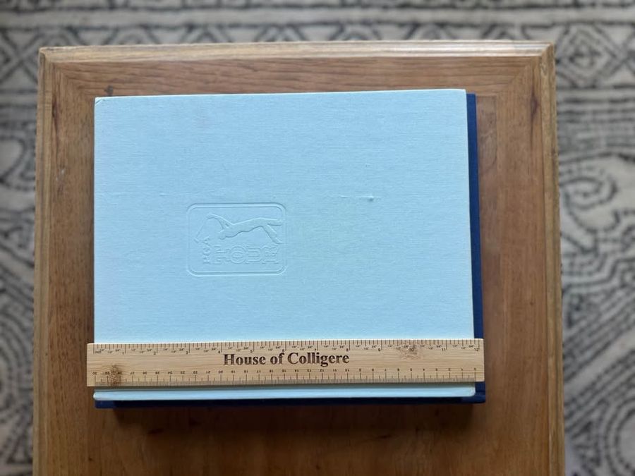 Coffee Table Design, Blue, Navy, Sky, linen-like cloth covers, matte woven texture, subtle gold and metallic lettering, understated traditional styling