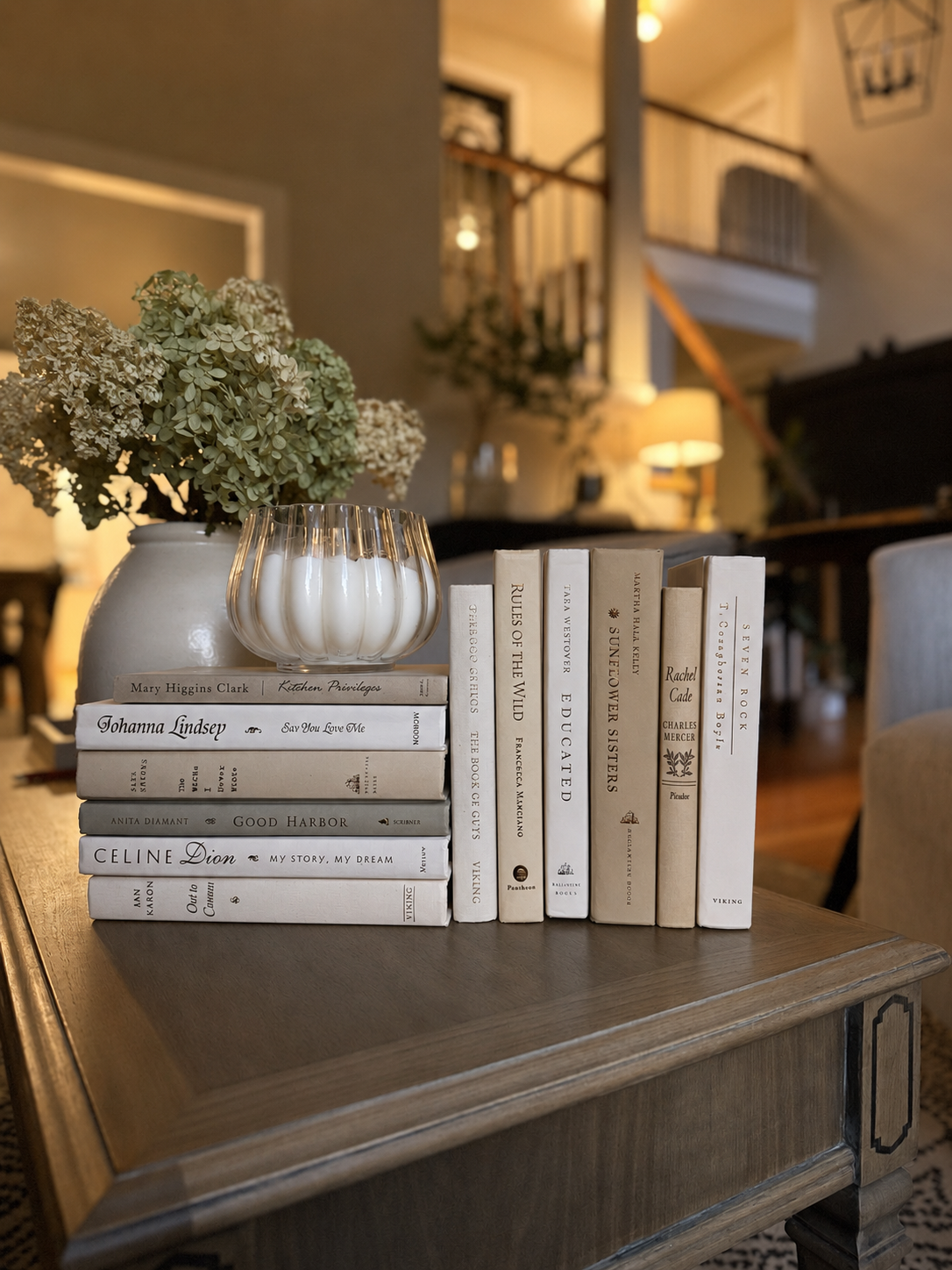 Curated collection of crisp white, ivory, and warm cream books with soft neutral tones.