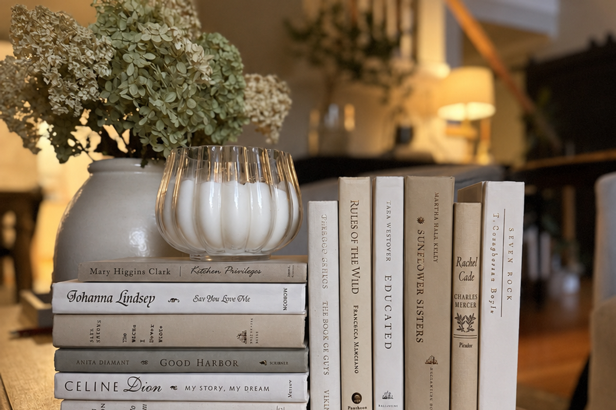 Curated collection of crisp white, ivory, and warm cream books with soft neutral tones.