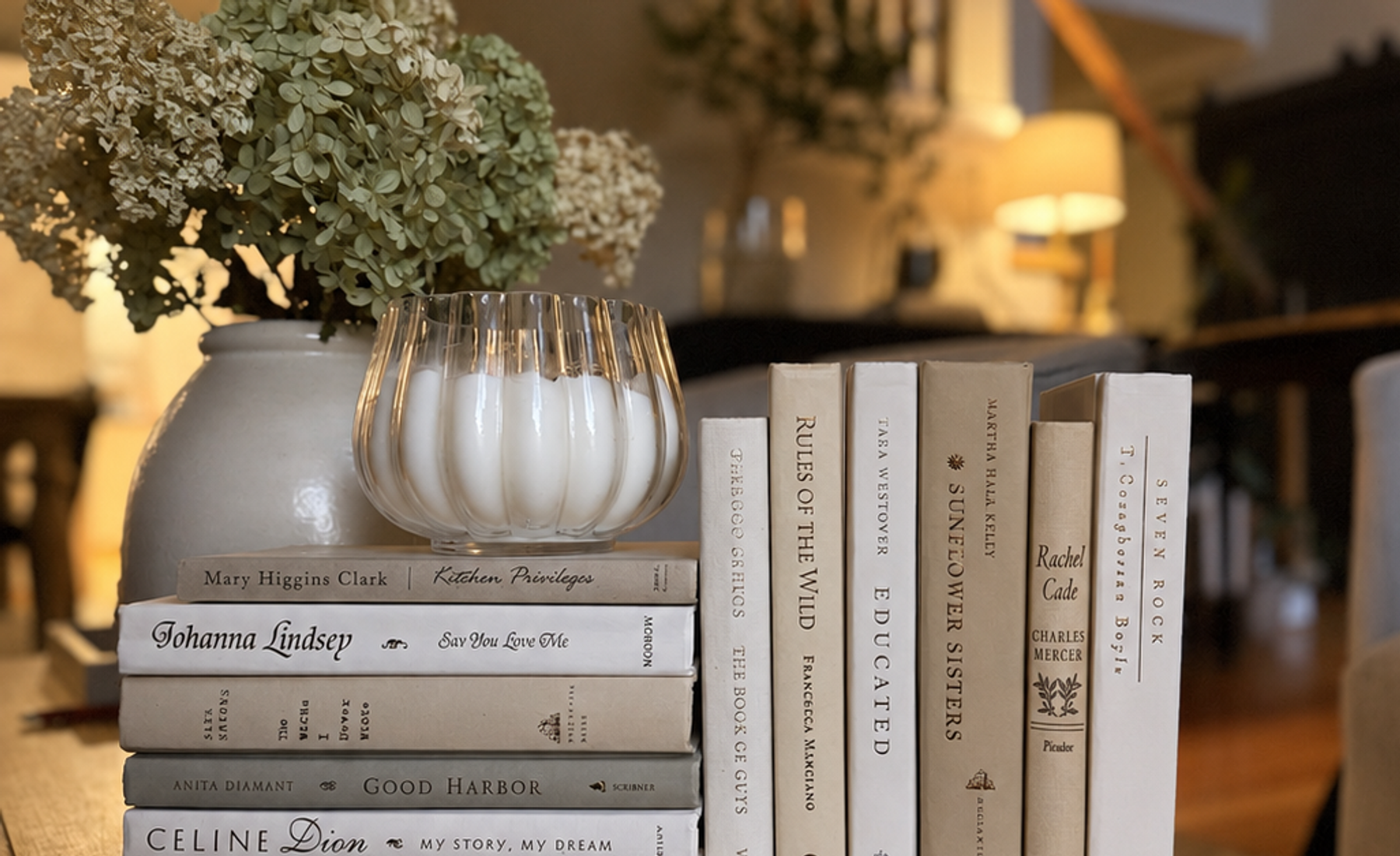 Curated collection of crisp white, ivory, and warm cream books with soft neutral tones.