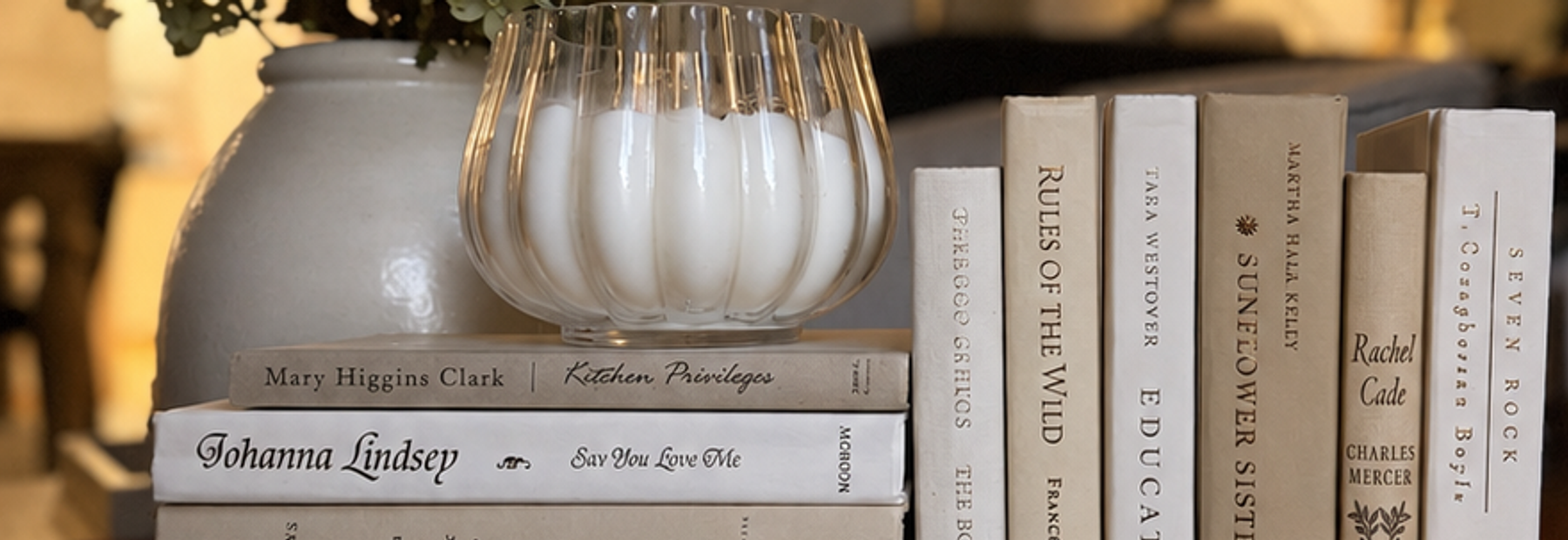 Curated collection of crisp white, ivory, and warm cream books with soft neutral tones.