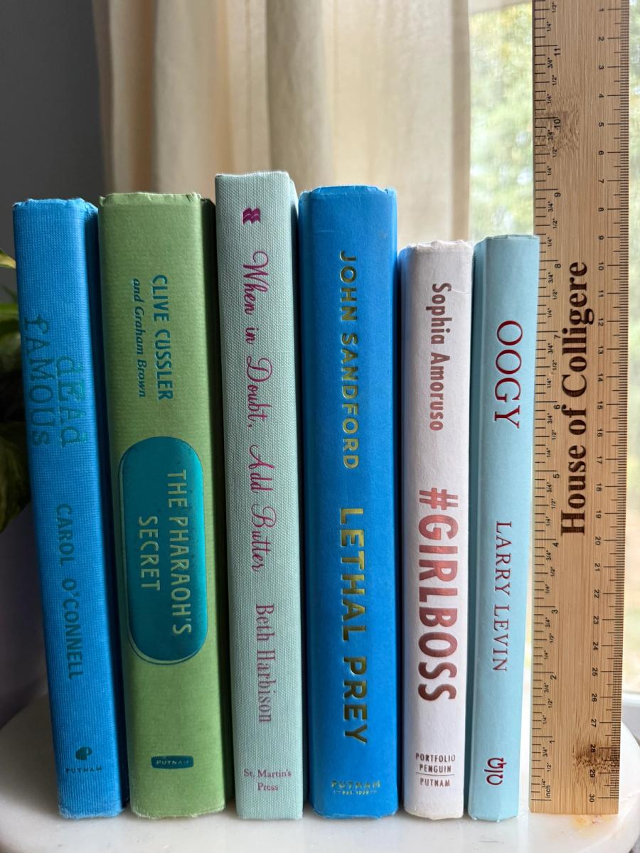 Curated collection of six hardcover books in cobalt blue, sage green, pale aqua, and soft white, tied with natural cotton ribbon and styled beside a House of Colligere collection card.