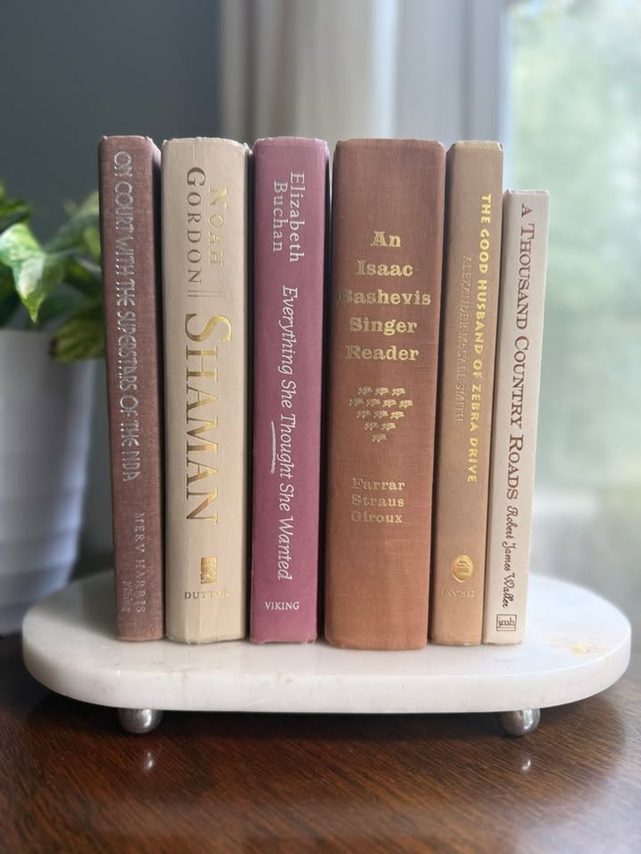 Curated collection of blush, dusty rose, warm taupe, and softly muted neutral books.