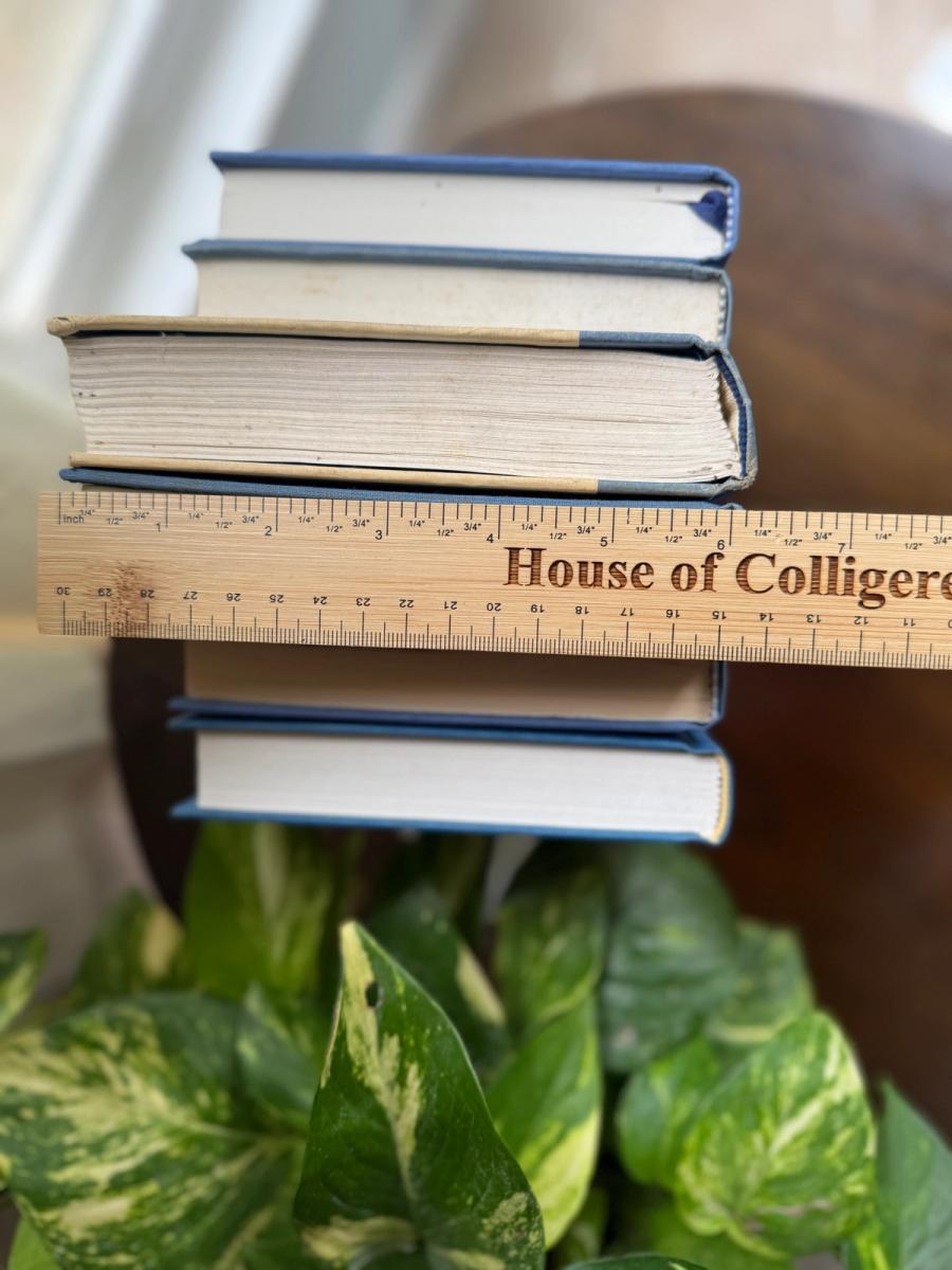 Curated collection of deep navy, warm ivory, brown, and gold-accented books with classic traditional character.