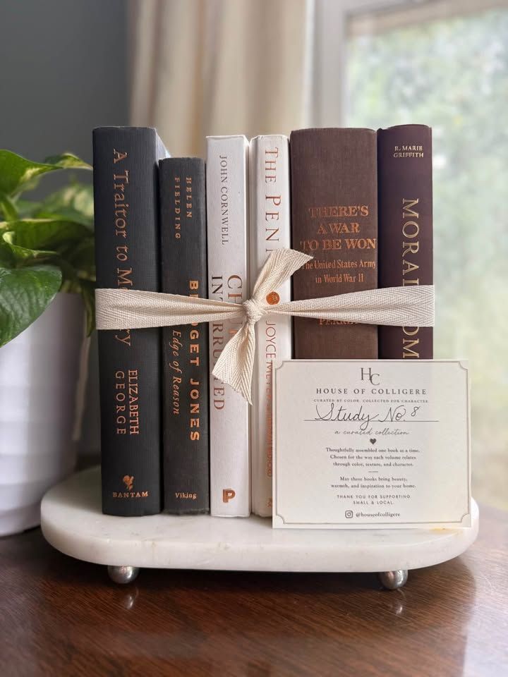 Curated collection of warm brown, olive, tan, and aged neutral books with a traditional library palette.