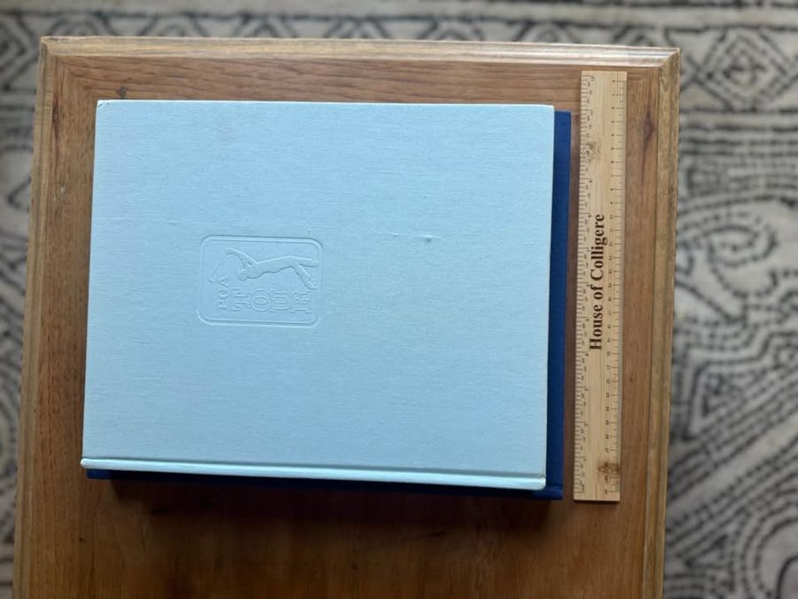 Coffee Table Design, Blue, Navy, Sky, linen-like cloth covers, matte woven texture, subtle gold and metallic lettering, understated traditional styling
