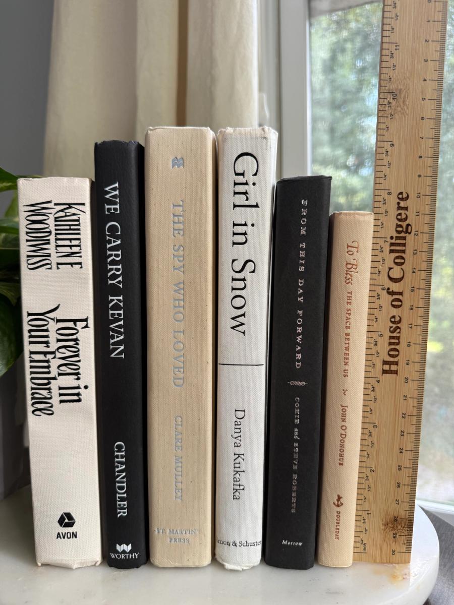 Curated collection of parchment, cream, warm beige, and black books with soft neutral contrast and classic detailing.