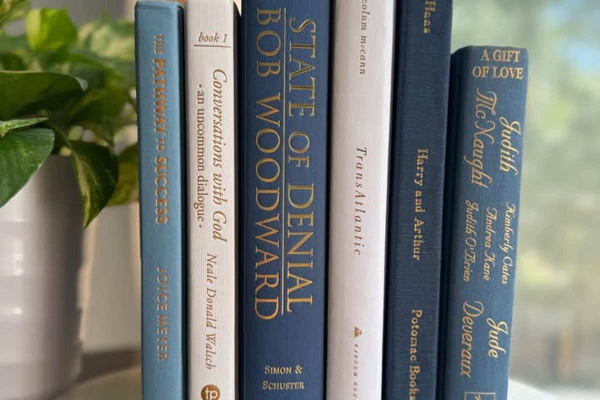 Curated collection of layered blue books ranging from pale coastal blue to deeper ocean tones.