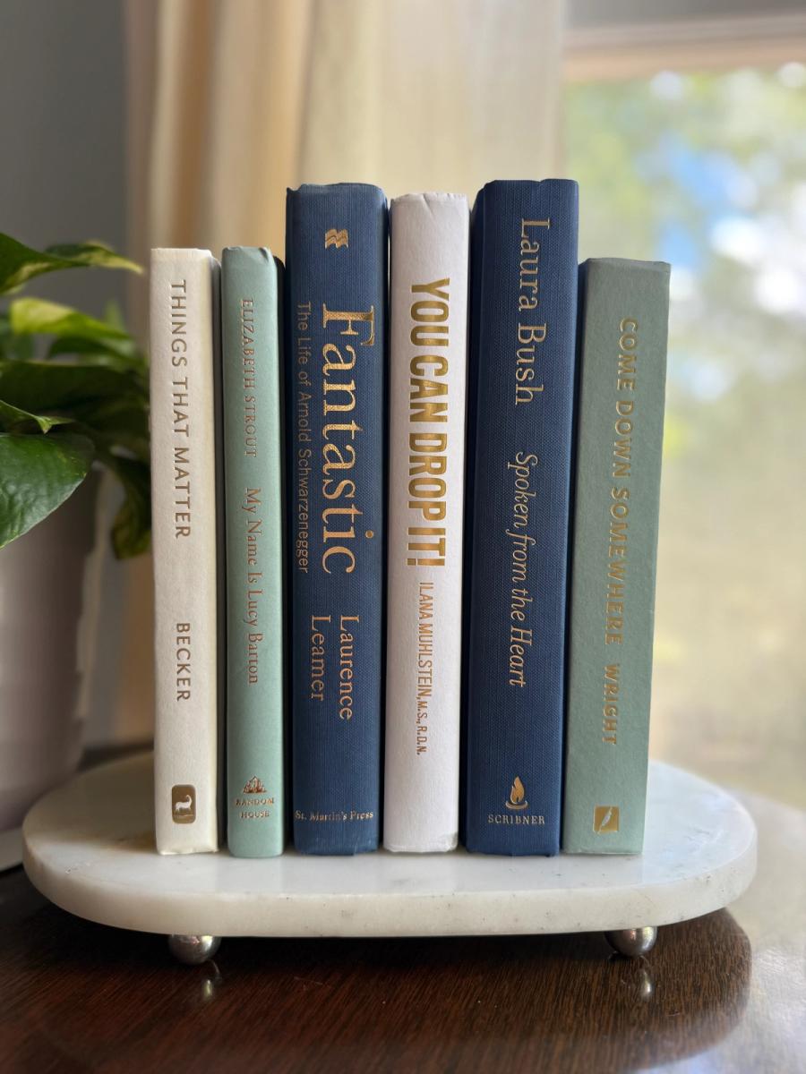 Curated collection of layered blue books ranging from pale coastal blue to deeper ocean tones.
