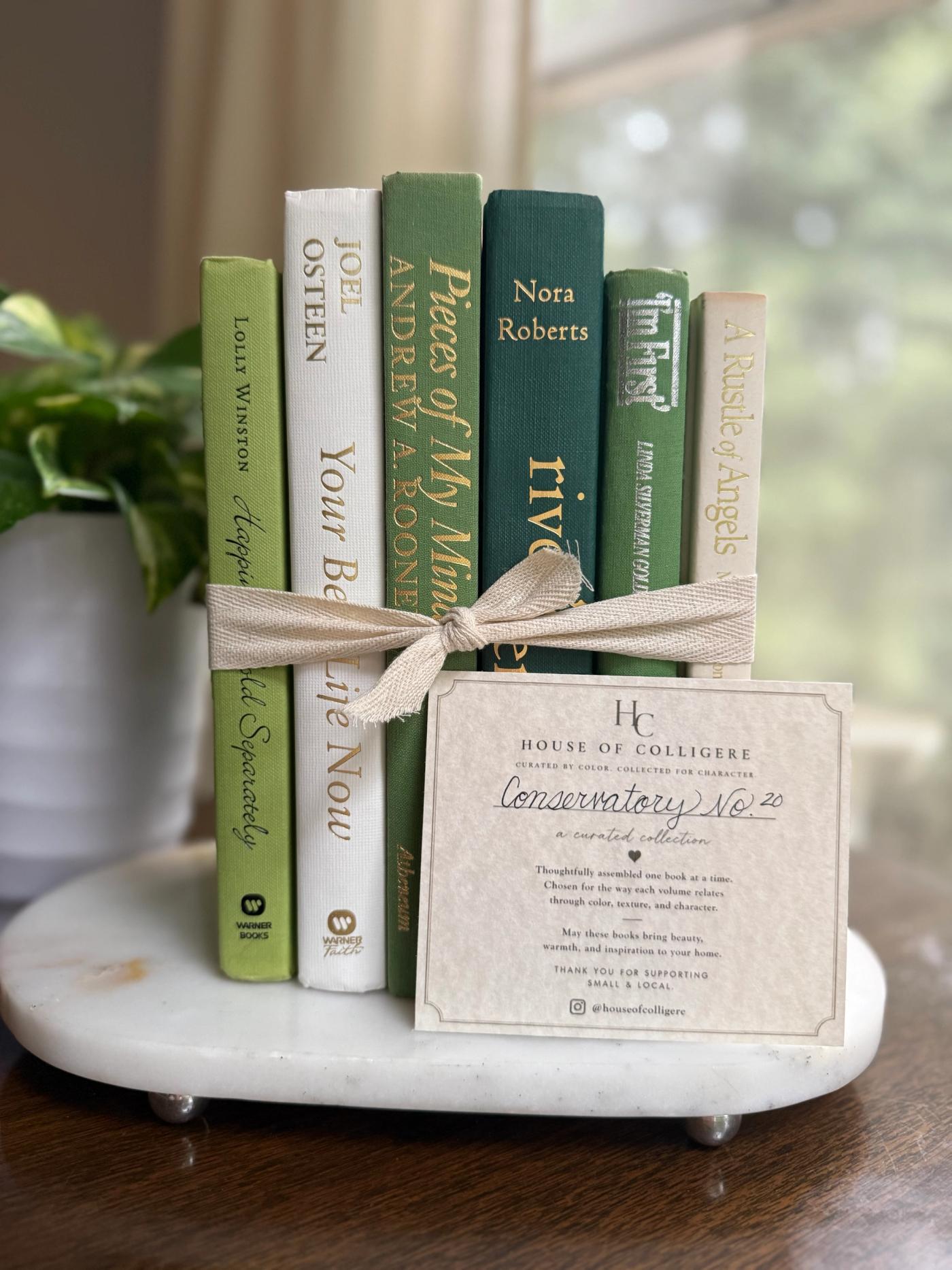 Curated collection of soft sage, olive, cream, and muted green books with botanical tones.