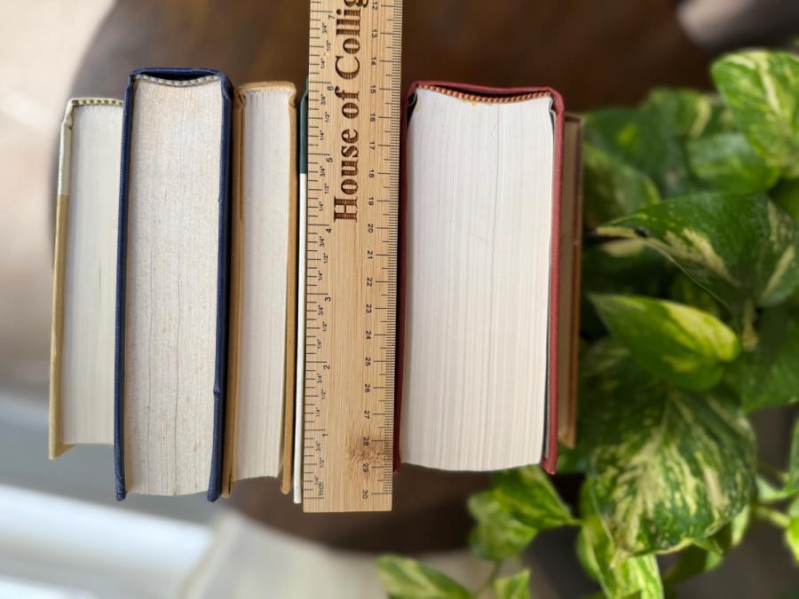 Curated collection of rich brown, hunter green, deep navy, and warm ivory books with classic gold accents.