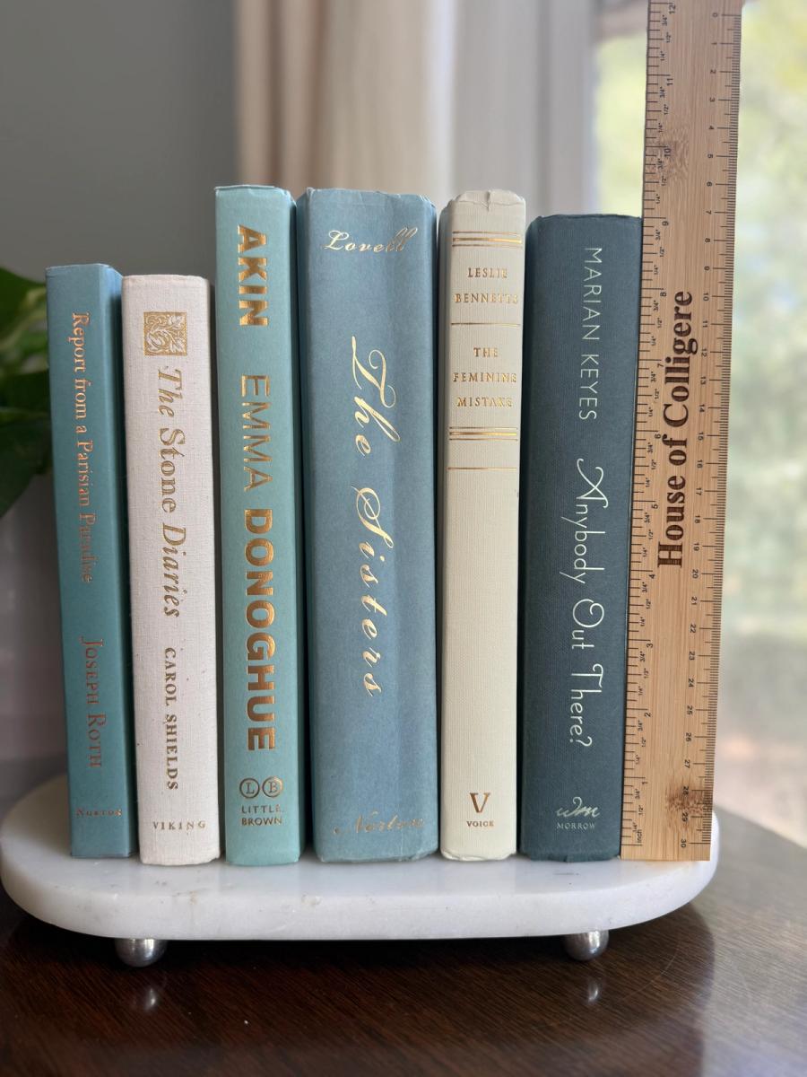 Curated collection of white, pale blue, sand, and soft coastal-neutral books with an airy, sun-faded look.