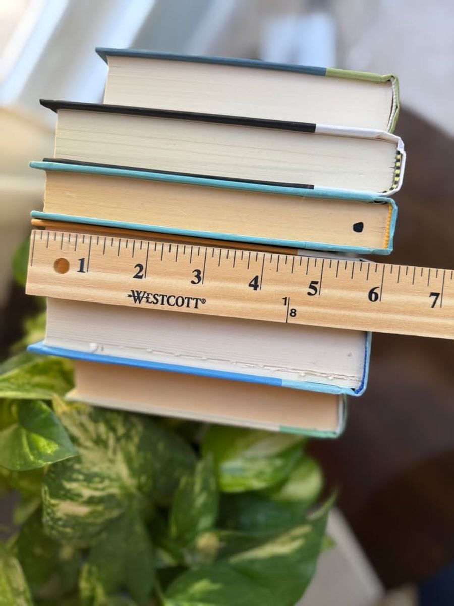 Modernist Edit No. 11 decorative book collection in fresh green, aqua, teal, ivory, and olive tones, tied with neutral linen ribbon and styled on a marble table.